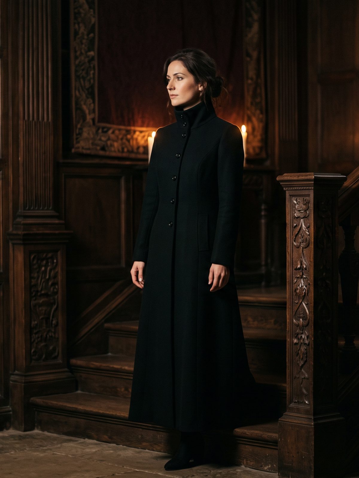 A woman in dark refined clothing, in warm low light